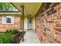 A close up of the brick wall and the front door of a charming home at 7580 Sherry Ln, Brownsburg, IN 46112