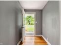 Open entryway featuring hardwood floors and a view of the green front yard at 7910 N College Ave, Indianapolis, IN 46240