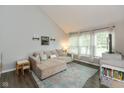 Spacious living room with large windows, a comfortable sectional sofa, and wood floors at 8958 Wooster Ct, Fishers, IN 46038