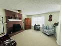 Cozy living room with a brick fireplace and a comfortable armchair at 932 Eagle Brook Cir, Shelbyville, IN 46176