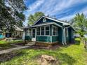 This lovely home features nice landscaping and a charming front porch at 946 N Somerset Ave, Indianapolis, IN 46222