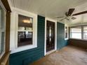 View of front porch with neutral flooring, windows, and ceiling fan at 946 N Somerset Ave, Indianapolis, IN 46222