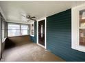 Bright and airy glass-enclosed front porch with ceiling fan and a view of the front yard at 946 N Somerset Ave, Indianapolis, IN 46222