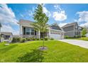 Charming home featuring a lush front lawn, professional landscaping, and a welcoming front entrance at 963 Booneway Ln, Bargersville, IN 46106