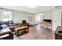 Cozy living room with a leather sectional, wood floors, and great natural lighting at 10972 W Old Nashville Rd, Columbus, IN 47201