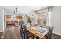 Bright dining area with wood table, backyard views, flowing to an open kitchen with modern finishes at 11209 Black Gold Dr, Noblesville, IN 46060