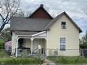Charming two-story home featuring a welcoming porch and a well-maintained, fenced yard under an overcast sky at 1164 Groff Ave, Indianapolis, IN 46222