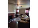 Cozy living room with brick fireplace, hardwood floors, and comfortable leather chairs at 1168 N Gladstone Ave, Indianapolis, IN 46201