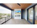 Covered outdoor deck with a wood-paneled ceiling and a brick fireplace at 120 First Ne Ave, Carmel, IN 46032