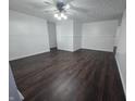 Bright living room featuring updated dark wood floors, white walls, and fan at 1263 Barefoot Trl, Greenwood, IN 46142