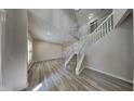 Bright foyer with wood-look floors, a staircase, and high ceilings, creating an open and inviting space at 12878 Ari Ln, Fishers, IN 46037