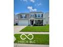 Charming two-story home with well-manicured lawn, lovely landscaping, covered front porch, and attached two-car garage at 12993 E 131St St, Fishers, IN 46037