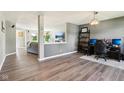 Spacious open-concept living area with gray walls, stylish gray flooring, neutral furniture, and an open floor plan at 12993 E 131St St, Fishers, IN 46037