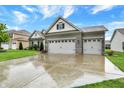 Attractive house with a three-car garage, a well-maintained lawn, and tasteful landscaping at 1334 Sunnybrook Ln, Greenwood, IN 46143