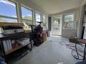 The enclosed porch offers natural light from multiple windows at 144 S 7Th Ave, Beech Grove, IN 46107
