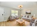 Bright, staged living room with comfortable seating, a neutral color scheme, and stylish decor at 16857 Palmetto Way, Noblesville, IN 46062