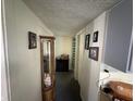 Hallway featuring pictures on the wall and a display cabinet with plenty of room for storage at 1801 E 16Th St, Muncie, IN 47302