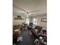 Inviting living room featuring a ceiling fan and windows for ample natural light at 1801 E 16Th St, Muncie, IN 47302