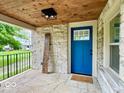 Beautiful stone porch with wood ceiling detail and a blue front door at 1920 E Epler E Ave, Indianapolis, IN 46227