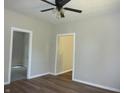 Bright bedroom featuring wood-look floors, neutral paint, and ceiling fan at 2007 Park Ave, Anderson, IN 46016