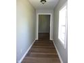 Inviting hallway with wood-look flooring, neutral paint, white trim, and natural light at 2007 Park Ave, Anderson, IN 46016