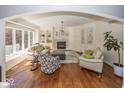 Bright living room with hardwood floors, fireplace, built-in shelves, and large windows at 21218 Carlton Ct, Noblesville, IN 46062