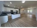 Spacious open-concept kitchen with white cabinets, stainless steel appliances, and a stylish center island at 223 N Coventry Dr, Anderson, IN 46012