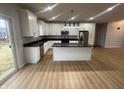 Bright kitchen with white cabinets, granite countertops and stainless steel appliances at 223 N Coventry Dr, Anderson, IN 46012
