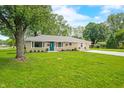 Well-kept home featuring a beautifully landscaped front yard and long driveway at 3027 Griffa Ave, Columbus, IN 47203