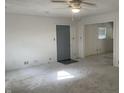 Carpeted living room with a ceiling fan and doorways at 3208 Wellington Ave, Indianapolis, IN 46226
