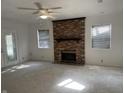 Bright living room featuring a brick fireplace and large windows at 3208 Wellington Ave, Indianapolis, IN 46226