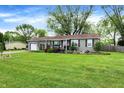 Cute ranch style home with a green lawn at 3552 N Talley Rd, Columbus, IN 47203