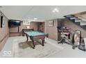 Finished basement area featuring a pool table, TV, and workout equipment at 3659 Watson Rd, Indianapolis, IN 46205