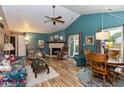 Bright living room with vaulted ceiling, wood floors, fireplace and sliding door to the backyard at 3754 Smallwood W Ln, Indianapolis, IN 46214