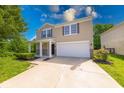 Charming two-story home features a covered porch, attached garage and manicured landscaping at 4055 Steelewater Way, Indianapolis, IN 46235