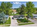 Aerial view of the home showcasing a spacious yard and proximity to greenery and farmland at 410 W Douglas St, Martinsville, IN 46151