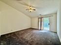 Spacious bedroom with plush carpeting, a ceiling fan, and sliding glass doors to the outdoors at 413 Woodberry Dr, Danville, IN 46122