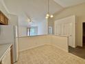 Bright, open kitchen area featuring tiled floors and a seamless transition to the living space at 413 Woodberry Dr, Danville, IN 46122