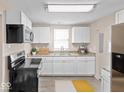 Modern kitchen with white cabinets, stainless steel appliances, and granite countertops at 429 Colescott St, Shelbyville, IN 46176