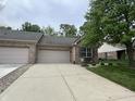 Charming brick home featuring a convenient attached garage and long driveway at 5486 Lipizzan Ln, Plainfield, IN 46168