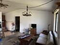 Spacious living room with rustic chandelier and a large window allowing for plenty of natural light at 5601 Milhouse Rd, Indianapolis, IN 46221