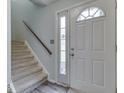 Bright entryway with staircase and stylish front door at 57 Trails End St, Greenwood, IN 46142