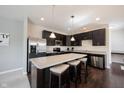 Modern kitchen with stainless steel appliances, granite countertops, and a breakfast bar at 635 Sonoma Ln, Greenfield, IN 46140