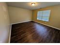 Comfortable bedroom with wood flooring, neutral paint, and natural light at 6715 Shanghai Cir, Indianapolis, IN 46278