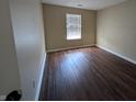 Cozy bedroom featuring modern floors and a sunlit window at 6715 Shanghai Cir, Indianapolis, IN 46278