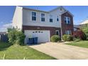 Two-story home with a brick-accented facade and an attached garage on a sunny day with nice landscaping at 6824 W Philadelphia Dr, McCordsville, IN 46055