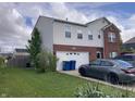 Two-story home with a brick and vinyl exterior, featuring an attached garage and a well-maintained lawn with landscaping at 6824 W Philadelphia Dr, McCordsville, IN 46055