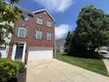 Two-story brick home featuring an attached garage and a well-maintained front lawn at 6924 Havenmoor Pl, Indianapolis, IN 46250