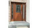 Elegant front door featuring decorative glass panels and a sidelight at 8130 Winterset Cir, Indianapolis, IN 46214