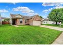 Lovely brick home with a well-kept lawn, mature landscaping, and a two-car attached garage at 8904 Browns Valley Ln, Camby, IN 46113